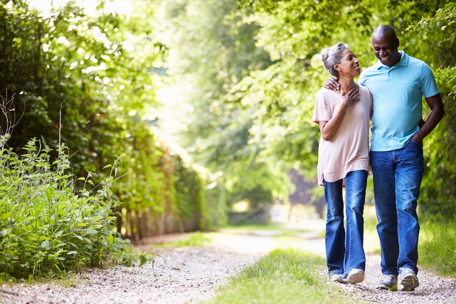 An older couple walking together on a country path
